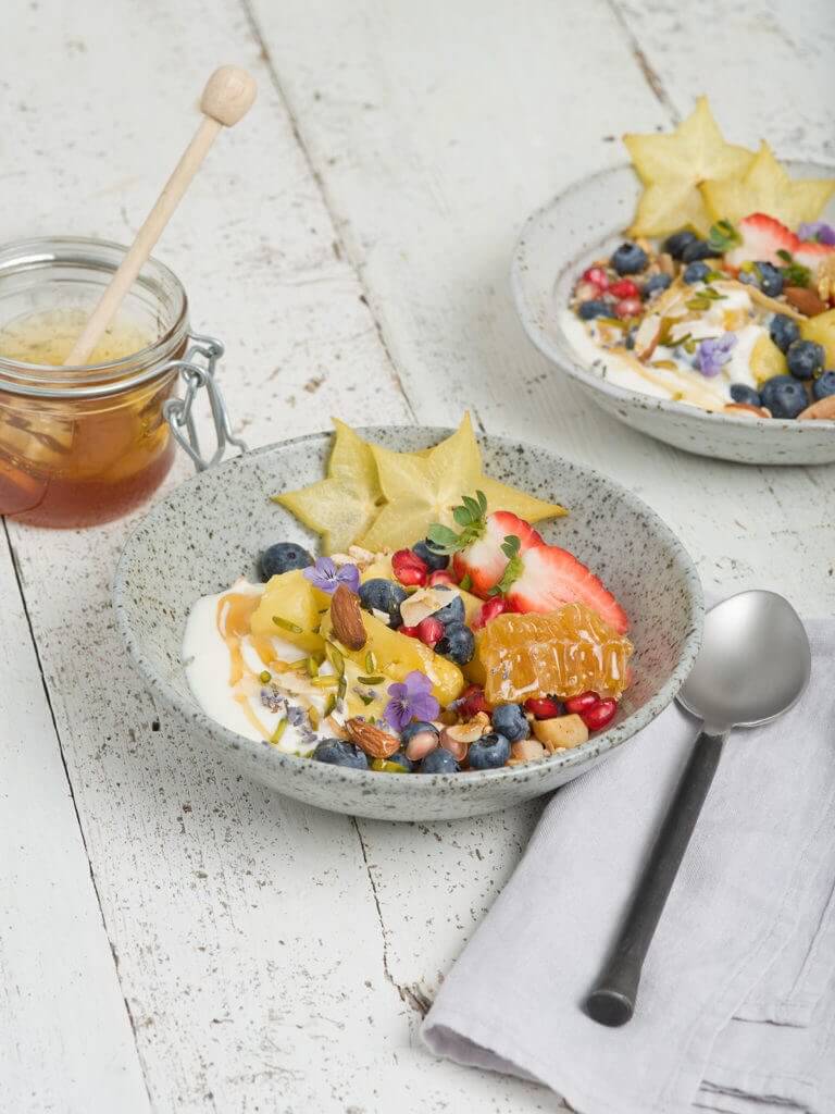 Miele desserts: Yoghurt with honey, starfruit, berries and pomegranate seeds
