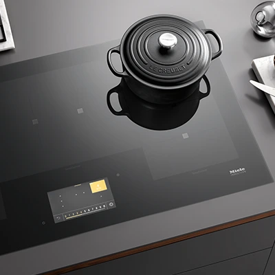 A Le Creuset dutch oven on a Miele induction cooktop.