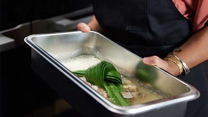 Pandan leaves tied in a knot and used as aromatics in Palisa's dish