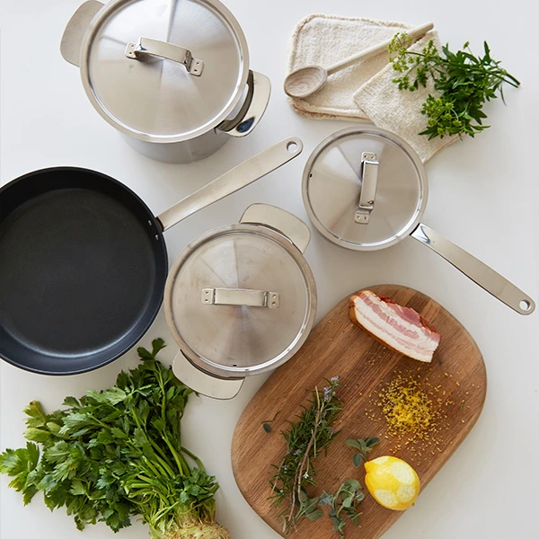 Miele induction cookware on display with food ingredients