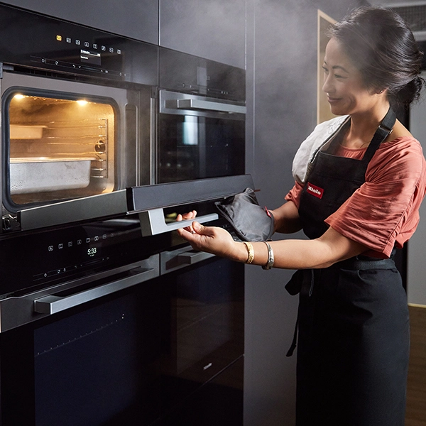 Palisa opening her Miele steam oven door