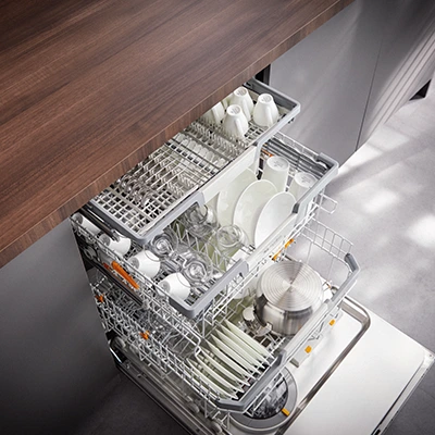 A fully stacked Miele dishwasher.