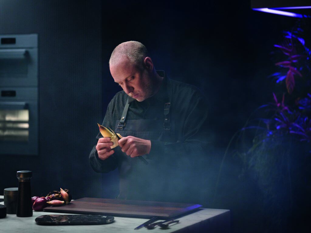 Chef peeling vegetable to cook using Miele Generation 7000 appliances